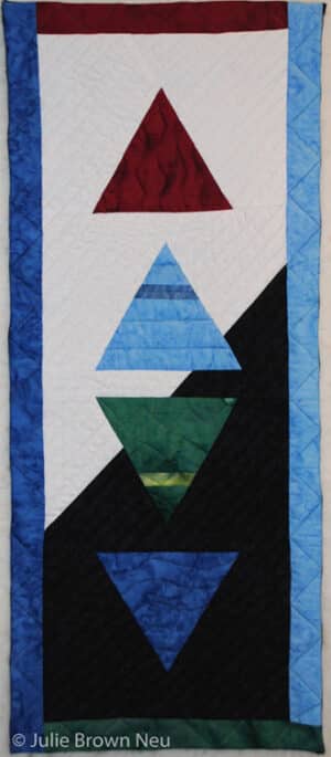 art quilt with symbols of 4 elements fire, air, earth, water