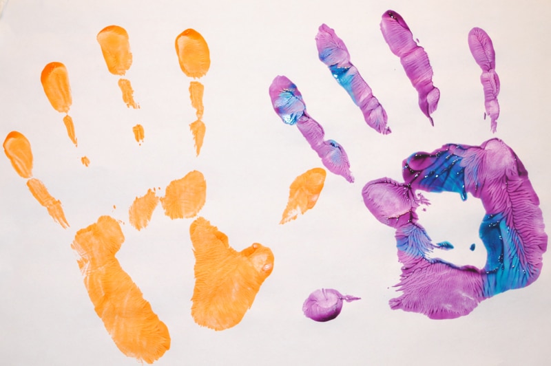 purple and orange painted hand prints