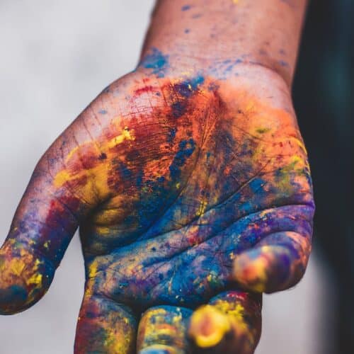 photo of person s hand with paint colors